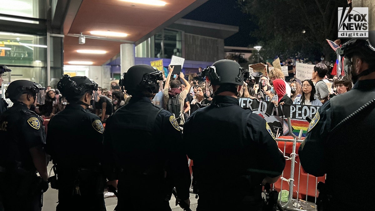UC-Berkeley far-left protesters next to police