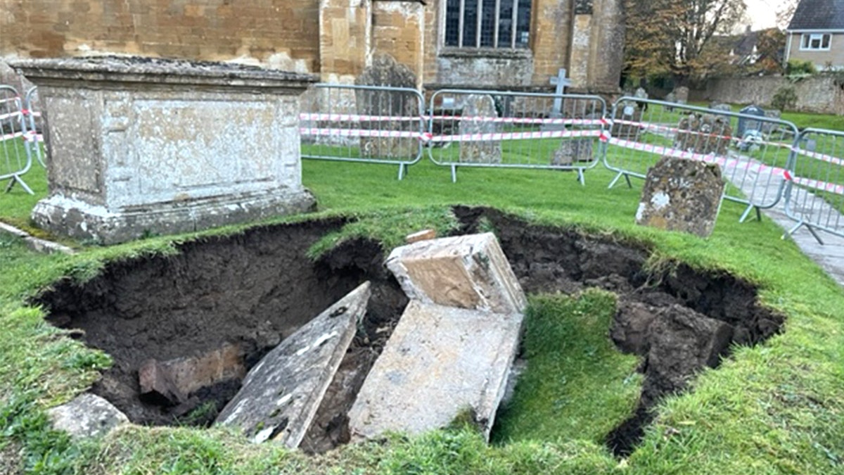 Wide view of collapsed stone in churchyard