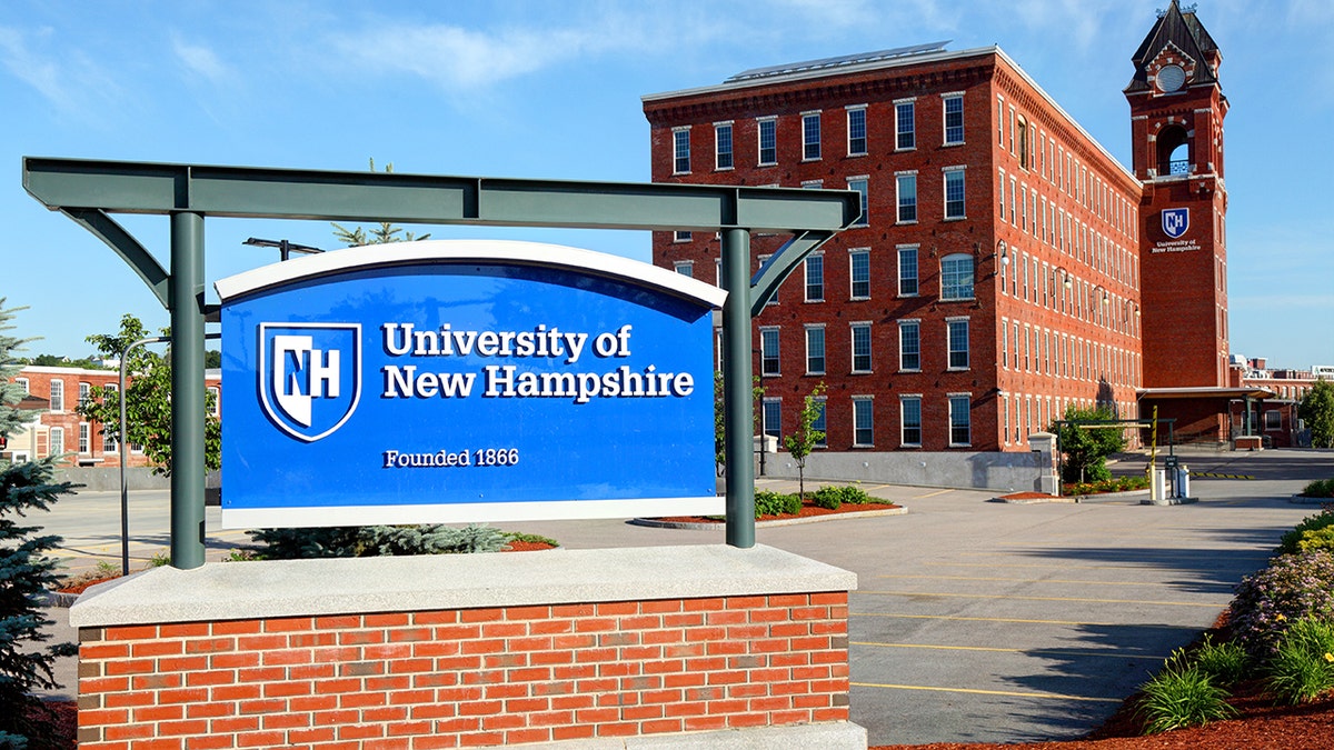 Blue university of new hampshire sign on brick base
