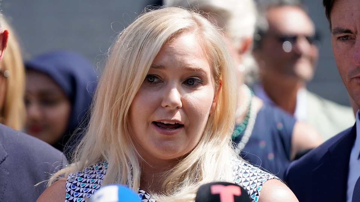 A close-up of Virginia Giuffre speaking to the press at a press conference.