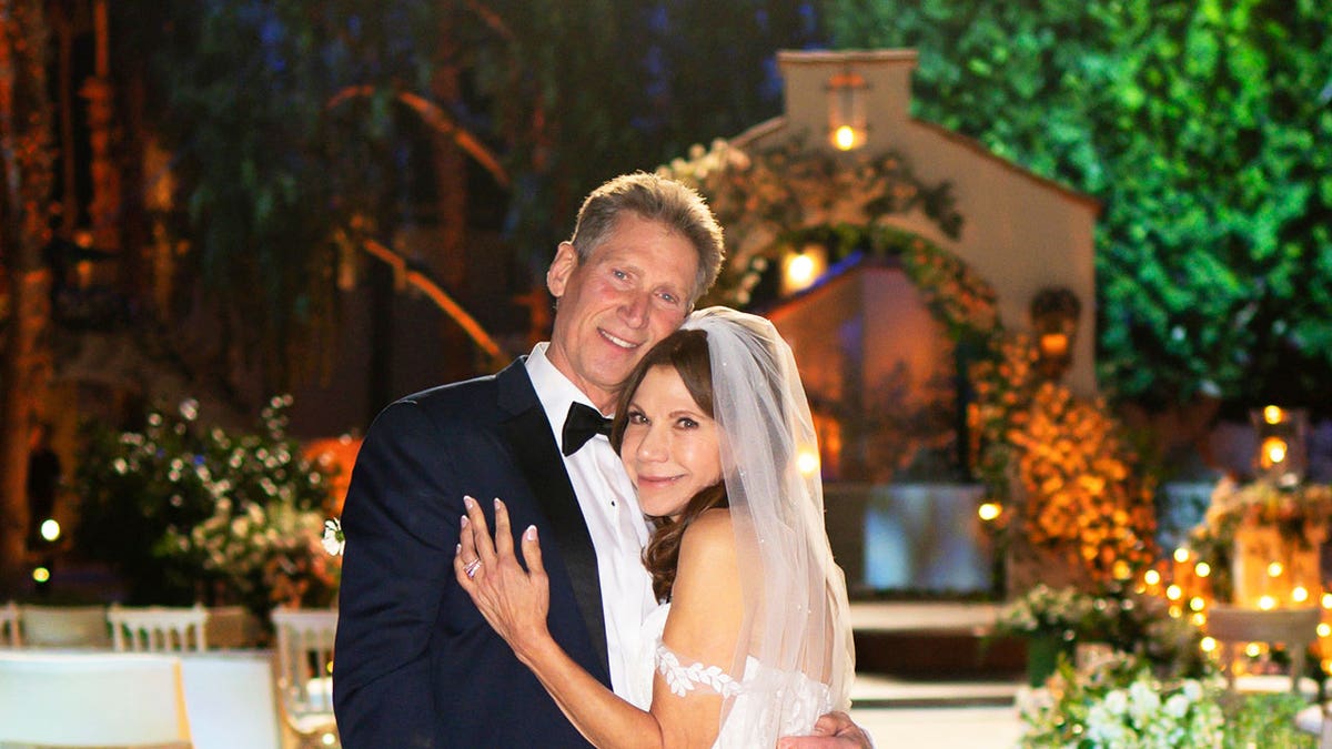 A close-up of Gerry Turner embracing Theresa Nist on their wedding day.