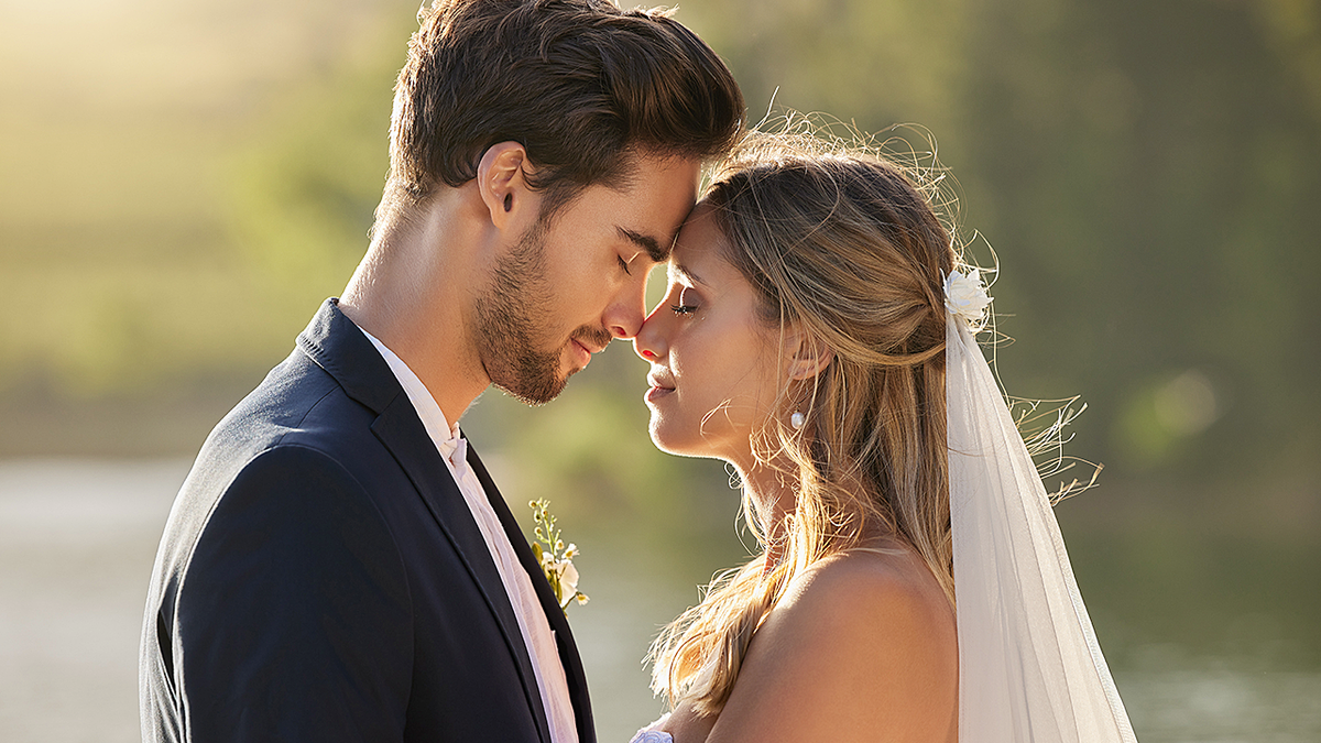 Newly married groom and bride embracing
