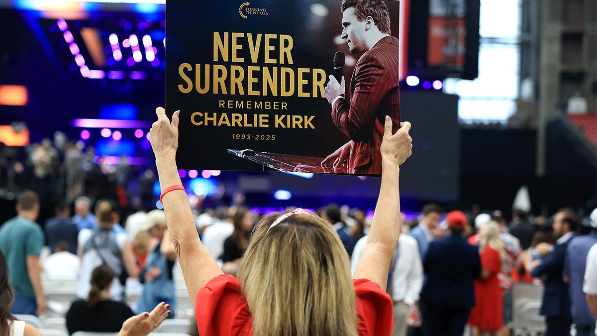 woman-holding-charlie-kirk-sign