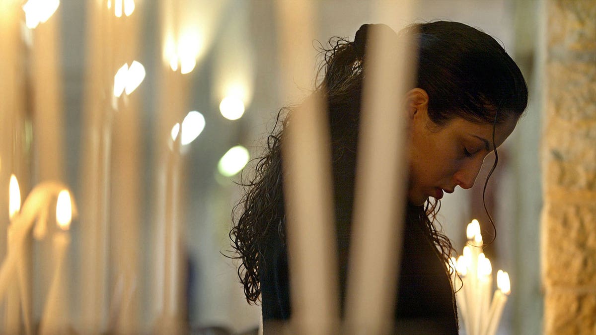 A Palestinian Christian woman prays inside St. Catherine’s Church in Bethlehem in 2022.