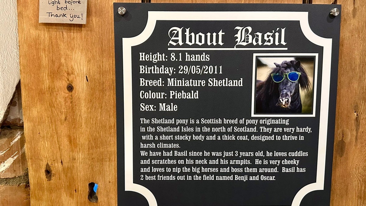 A wooden wall displays a sign titled