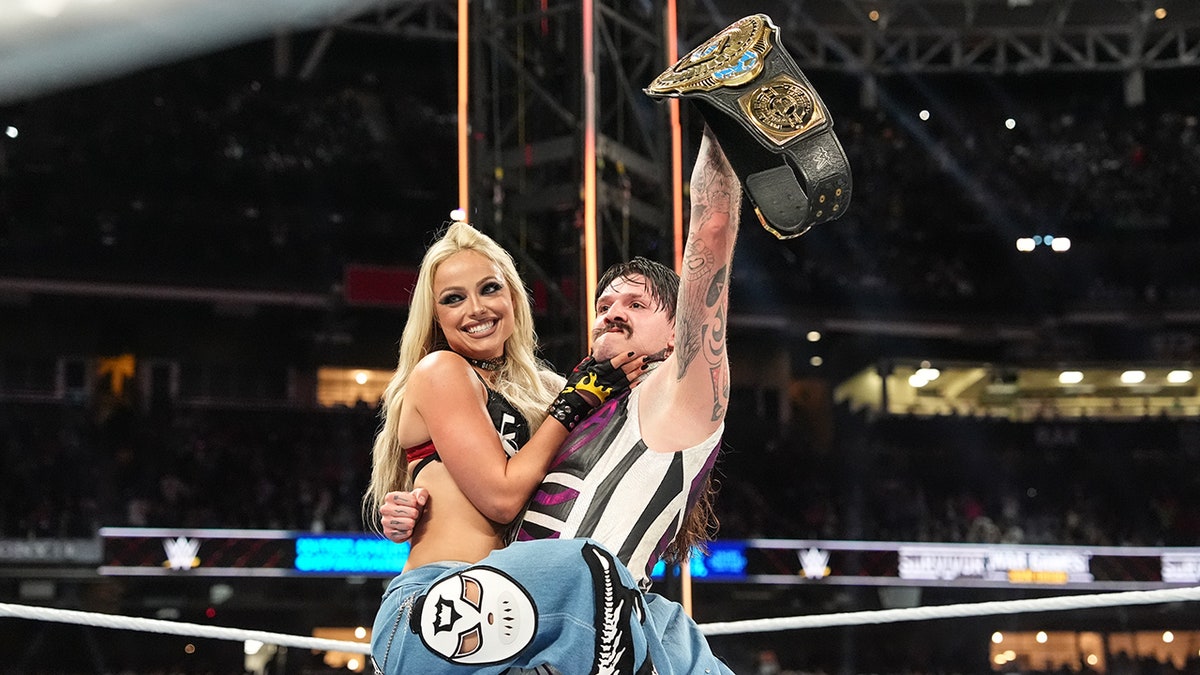 Liv Morgan celebrates with Dominik Mysterio