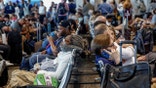 Travelers wait at an airport
