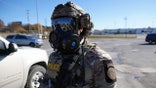 U.S. Border Patrol agent wearing goggles and a mask in a parking lot in Charlotte, North Carolina.