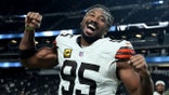 Myles Garrett celebrating on the field during a football game in Las Vegas