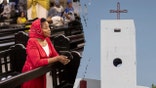 A general view of a catholic Church in Maiduguri and a woman praying.