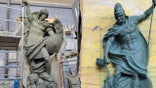 Two bronze statues shown side by side: on the left, a muscular winged figure of Saint Michael holding a shield and spear while standing on a subdued demon; on the right, Saint Florian in Roman armor pouring water from a vessel onto flames rising from a small building.