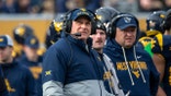 West Virginia football head coach Rich Rodriguez on field