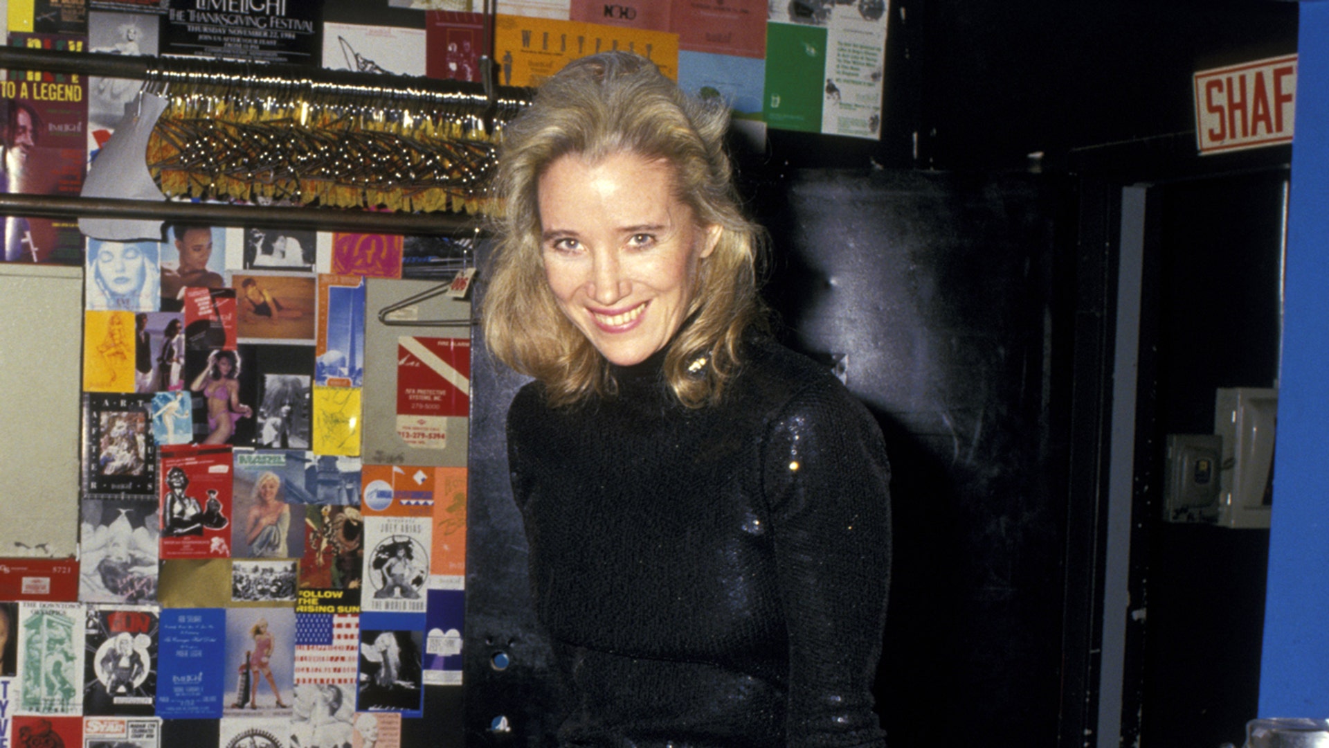 Sally Kirkland wears a short black dress