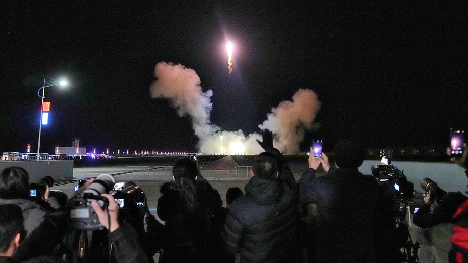 people watching Shenzhou-21 rocket launch