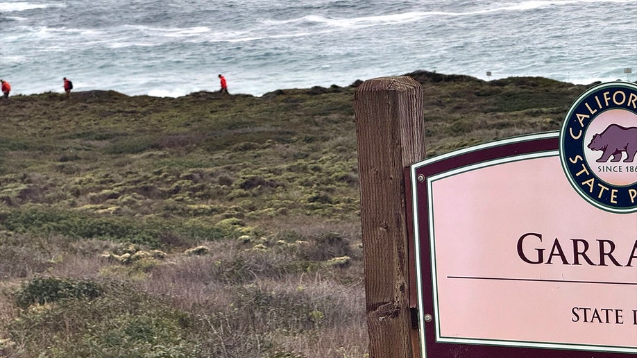 search squad  walking on  shoreline and a motion   successful  the foreground