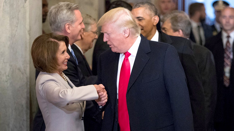 Nancy Pelosi and Donald Trump shake hands in 2017