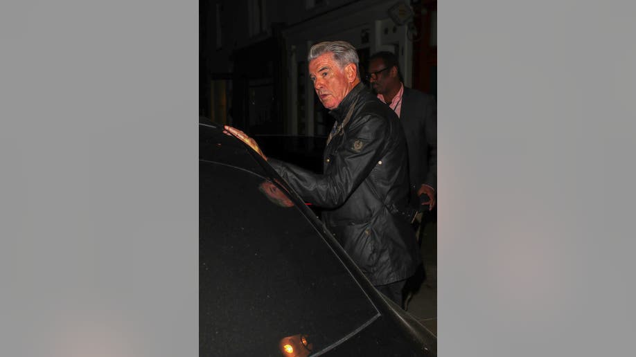 Pierce Brosnan gets into a car after leaving Dorian restaurant in London following a family dinner.