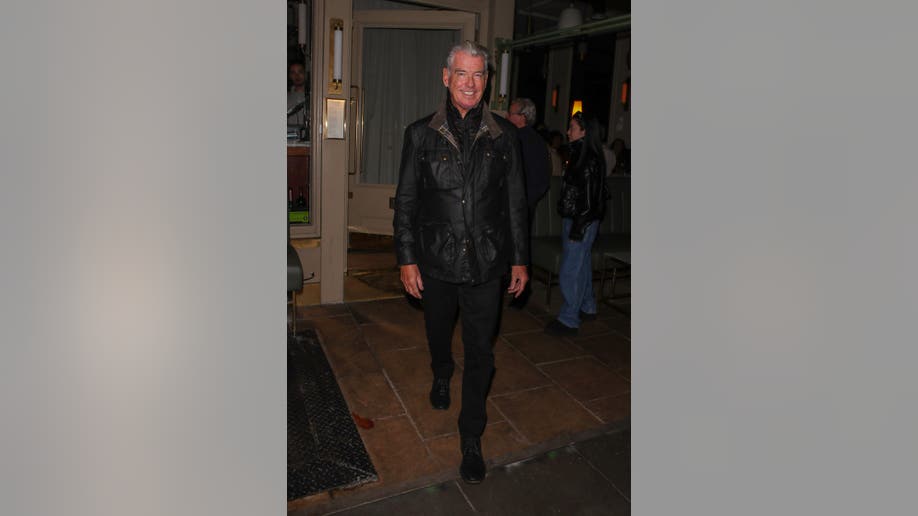 Pierce Brosnan smiles while leaving Dorian restaurant in London after a family dinner.
