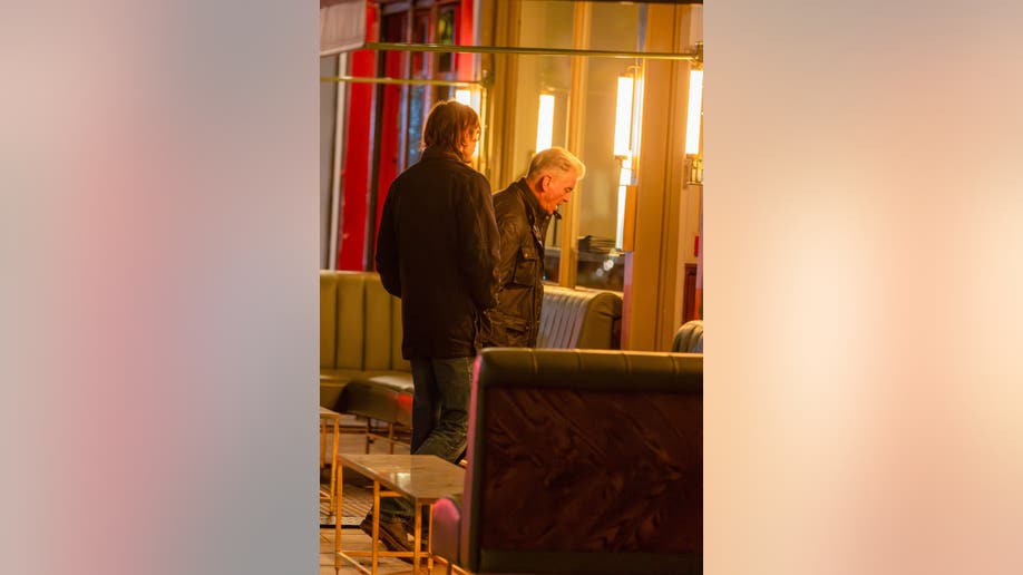 Pierce Brosnan and his son Dylan Brosnan stand inside Dorian restaurant in London during a family dinner.