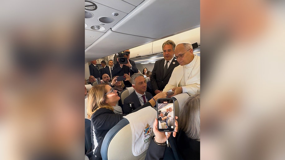Pope Leo meeting journalists on plane to Turkey.