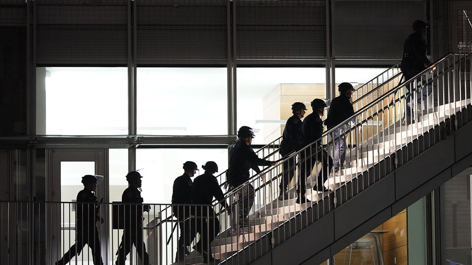 Police at TPUSA event at Berkeley walk up the stairs