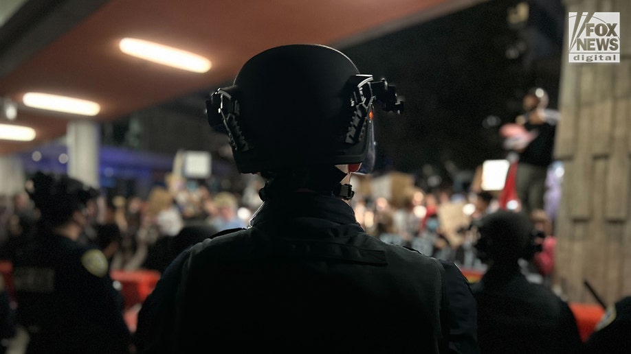 UC-Berkeley far-left protesters next to police