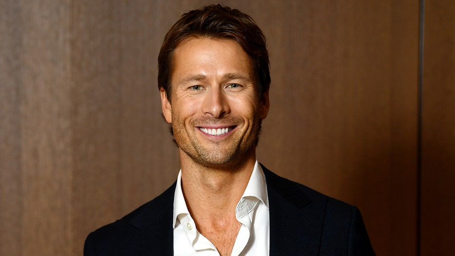 Internet InfoMedia glen powell smiling suit