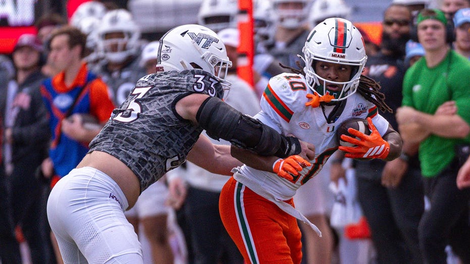 Miami football staffer avoids disaster after Hurricanes player barrels over her
