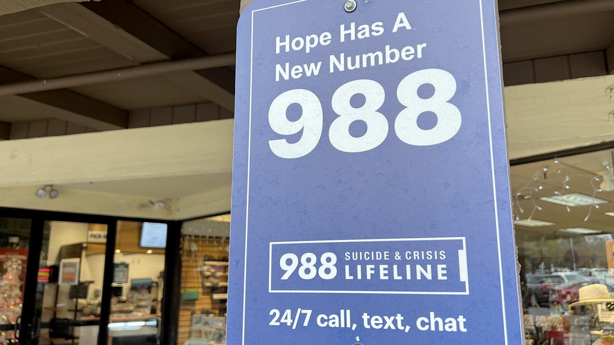 Sign displaying the 988 number for immediate mental health crisis support.