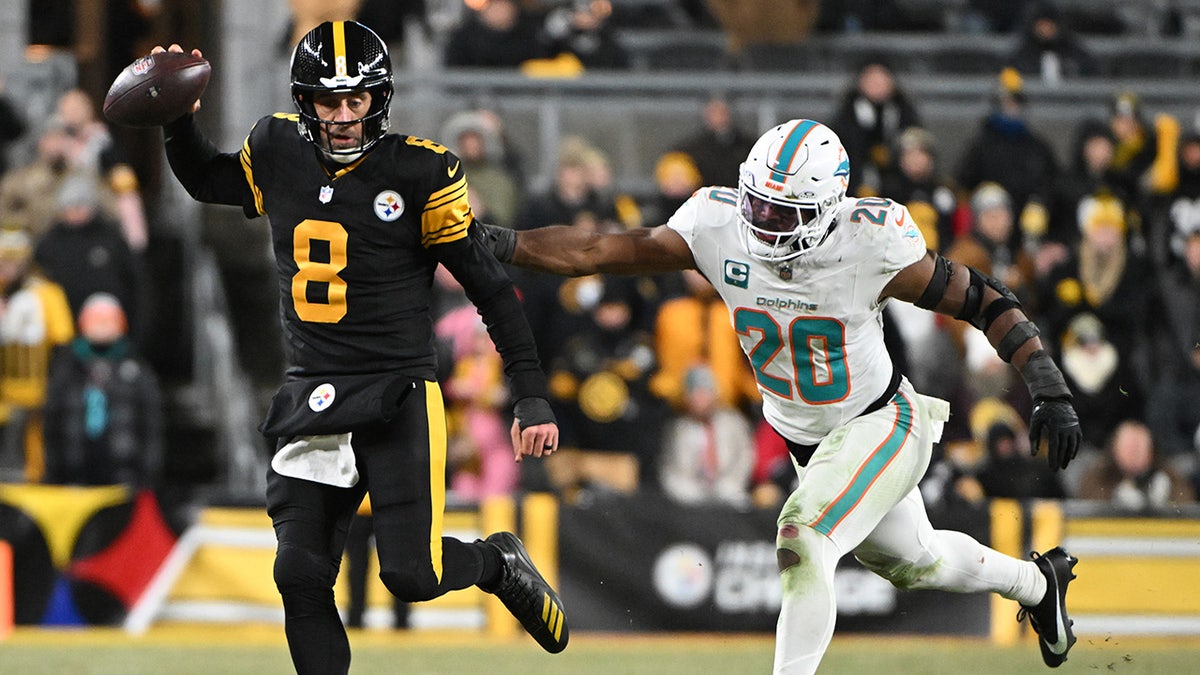 NFL players Aaron Rodgers and Jordyn Brooks during a game