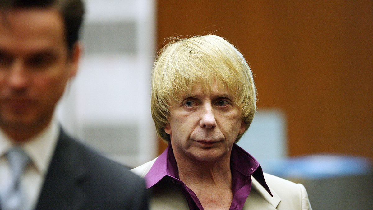 Phil Spector, right, glares at a young prosecutor named Alan Jackson in court