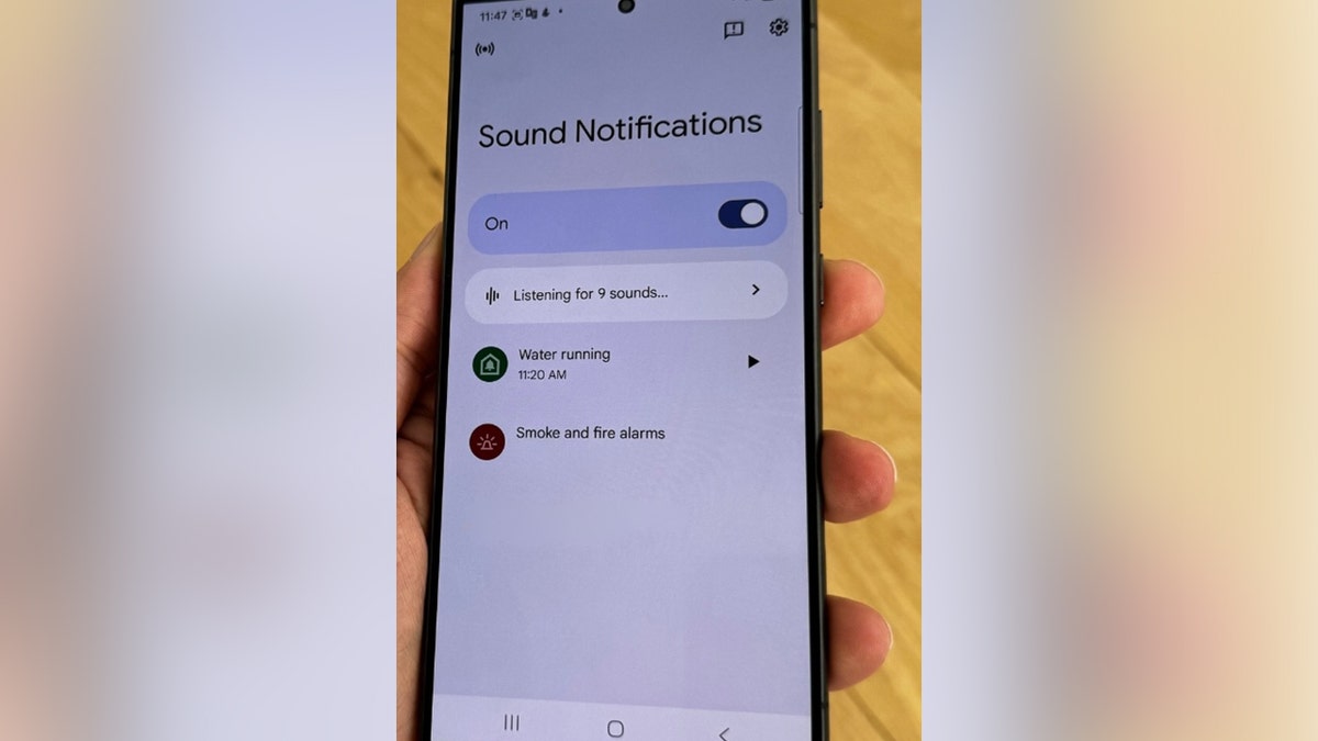 Person holding Android with Sound Notifications on the screen.