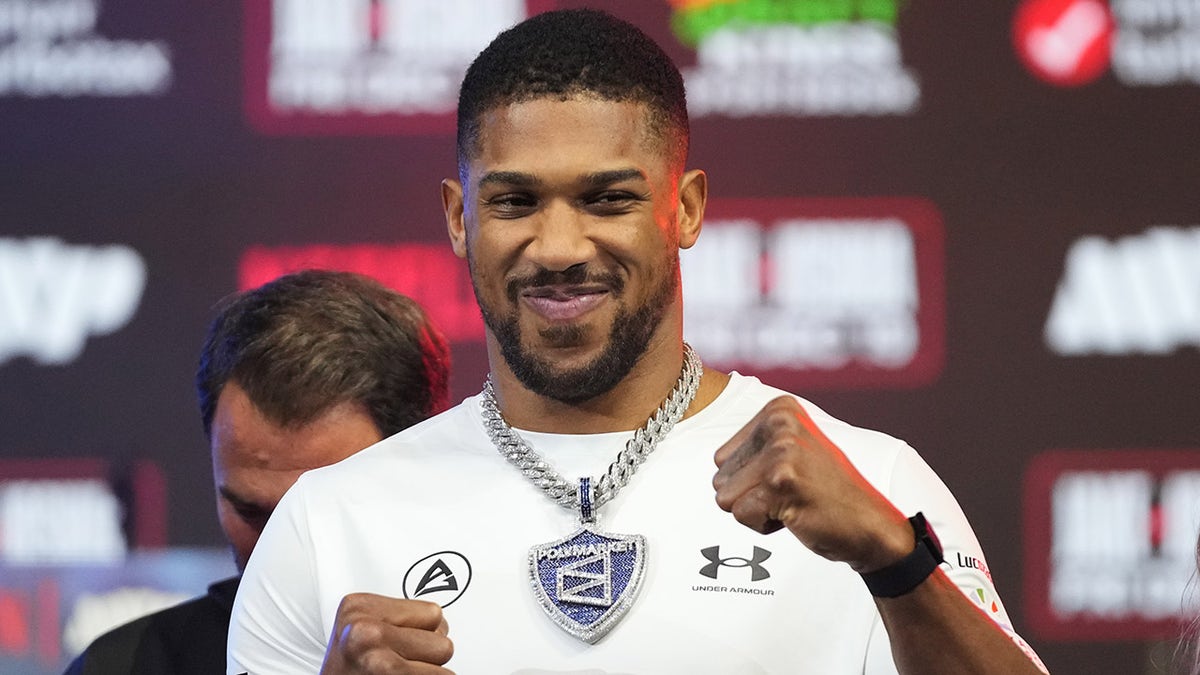 Anthony Joshua smiles at a press conference