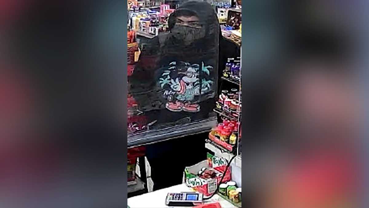 man in black hoodie at convenience store