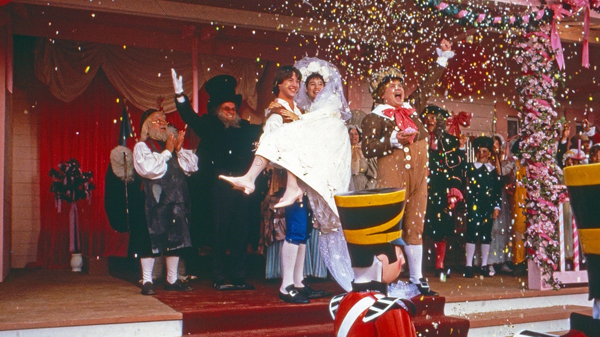 Keanu Reeves carrying Jill Schoelen in a scene from "Babes in Toyland."