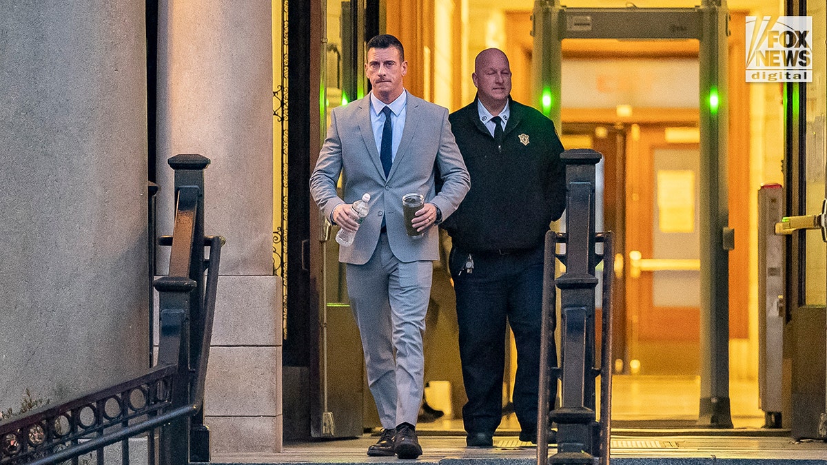 Trooper Nicholas Guarino leaving court in a gray suit