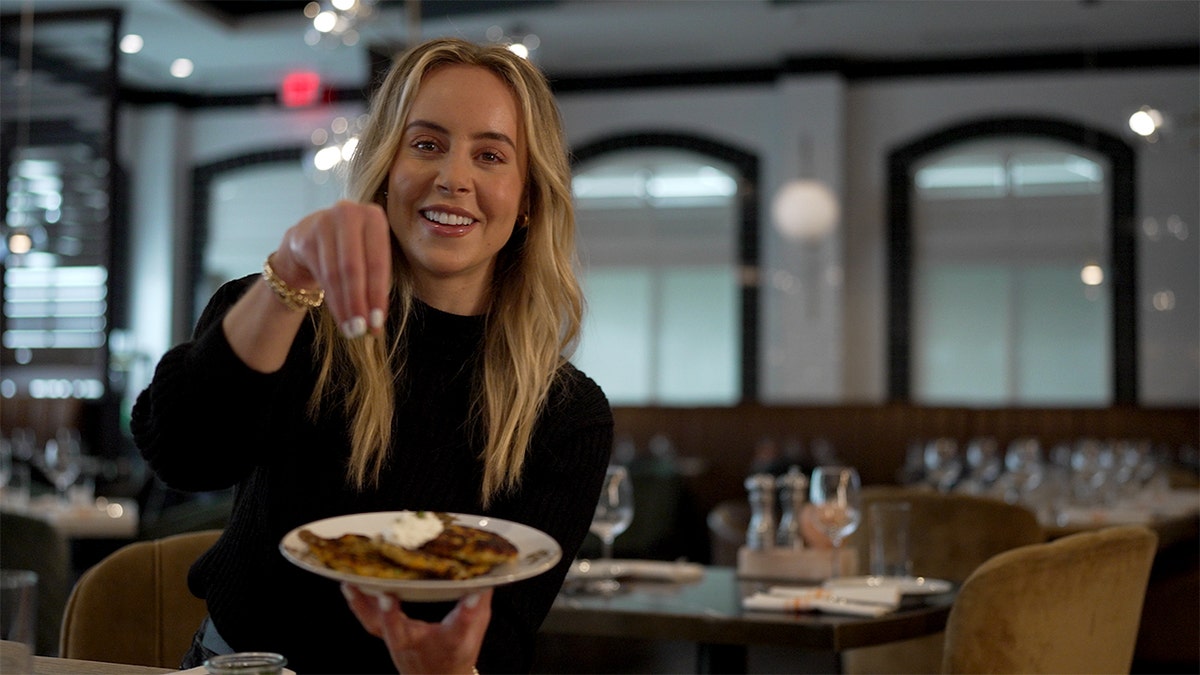 Brooke Baevsky holds a plate of Latkes.