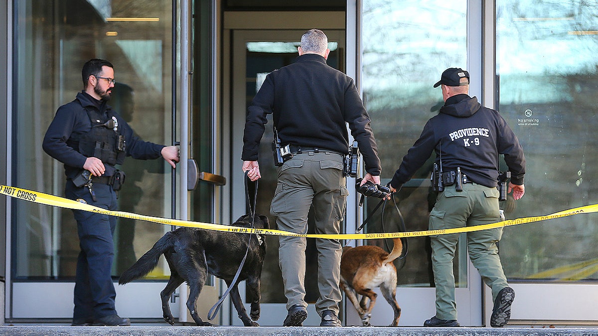Providence Police officers head into the Barus and Holley building on the campus of Brown University