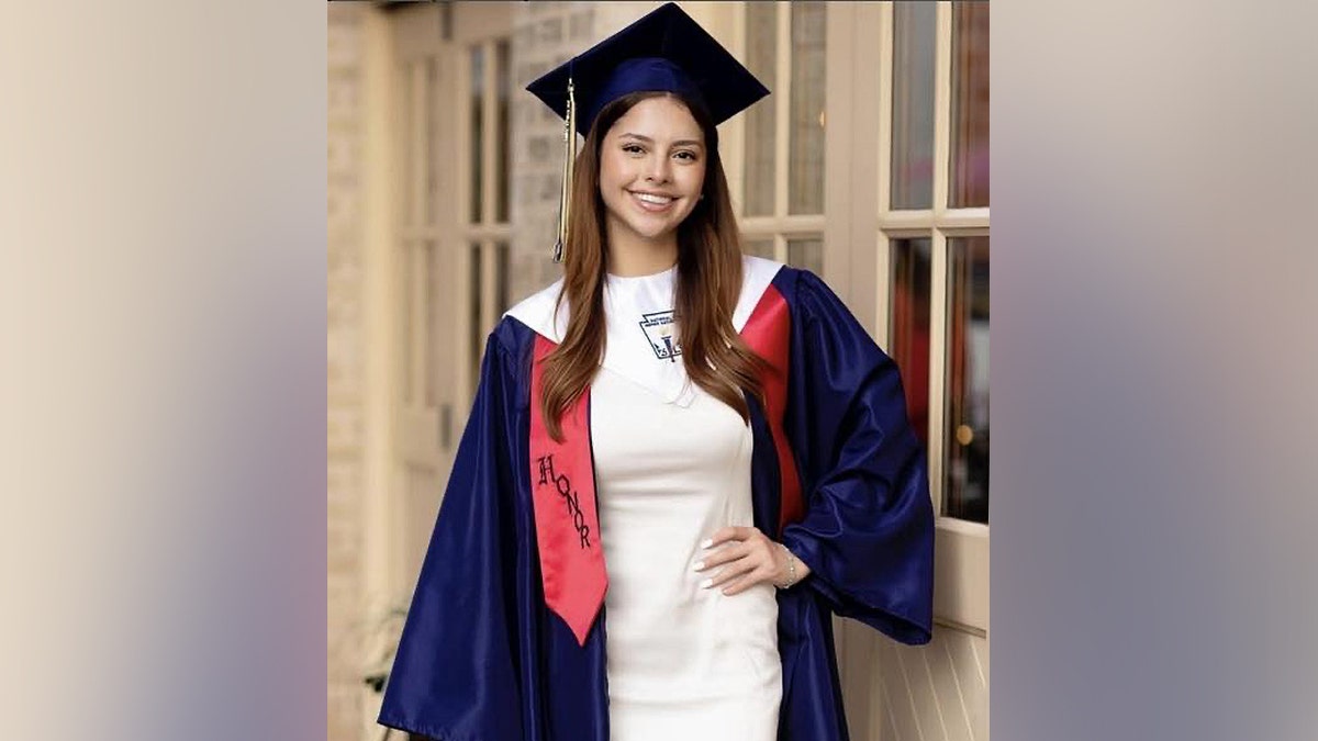Camila Olmos successful  her graduation headdress  and gown.