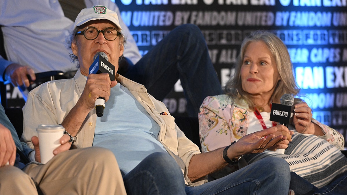 Beverly D'Angelo looking at Chevy Chase as he speaks.