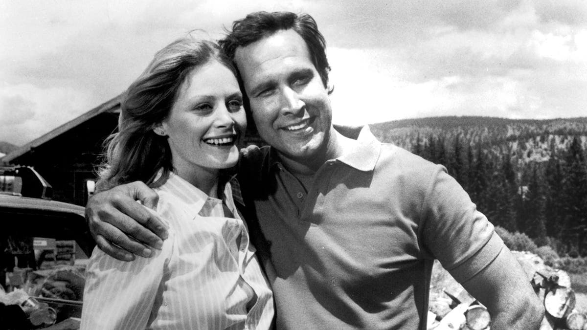 Chevy Chase embracing Beverly D'Angelo.