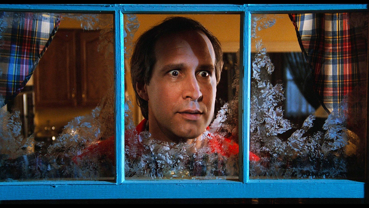 Chevy Chase looking out from a window.