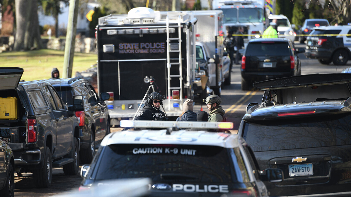 Law enforcement officers respond near a home where a man shot at officers