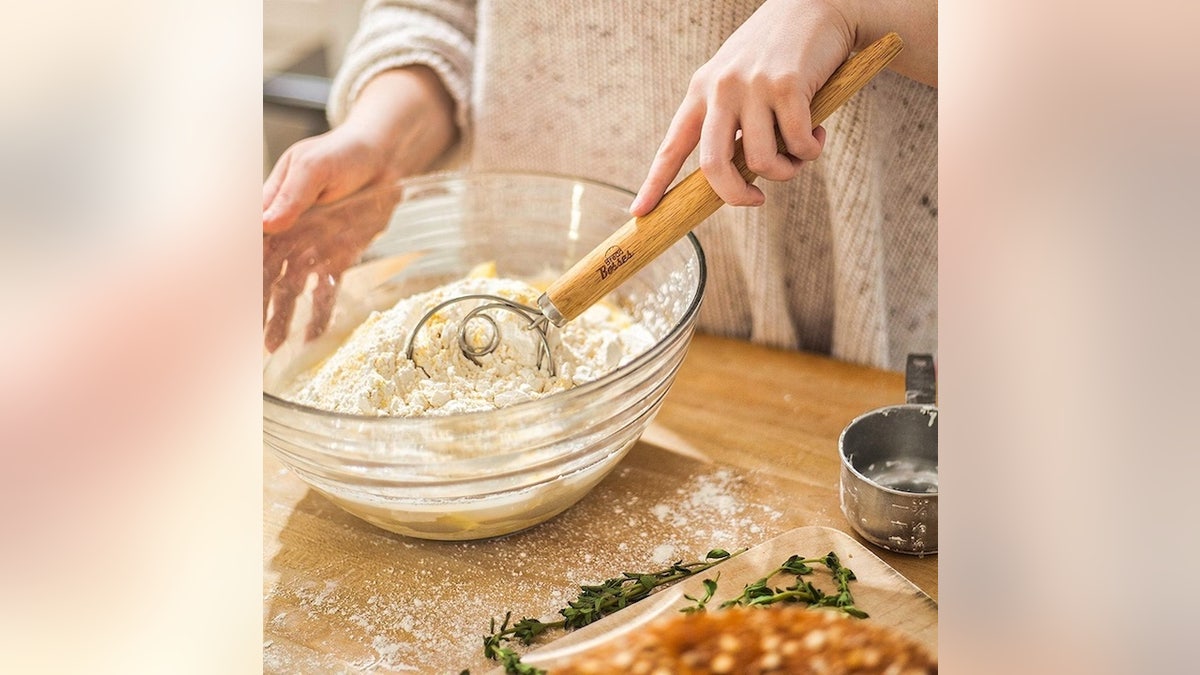 Skip sticky hands and clumpy messes with this dough whisk.