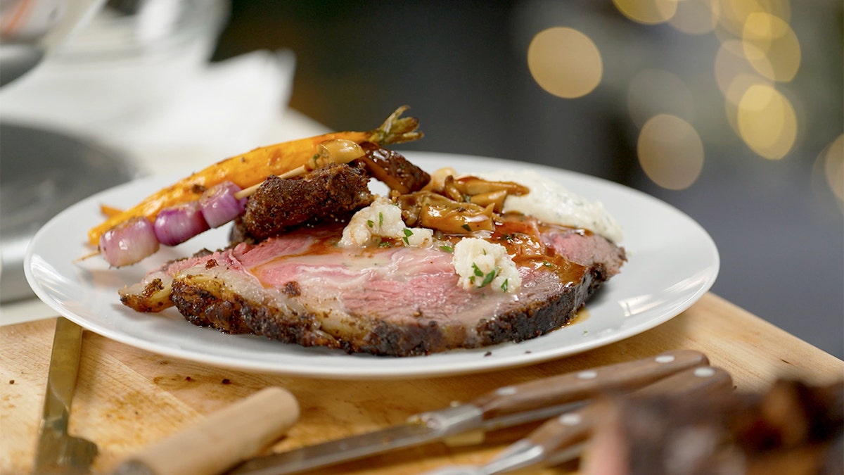 Prime rib and vegetables on a plate.