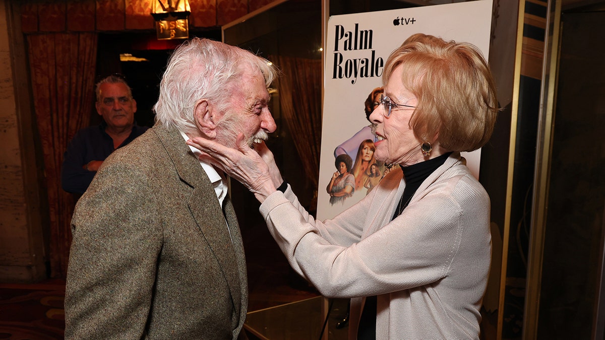 Carol Burnett houdt het lachende gezicht van Dick Van Dyke vast.