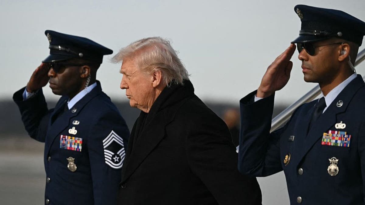 Donald Trump stands with soldiers