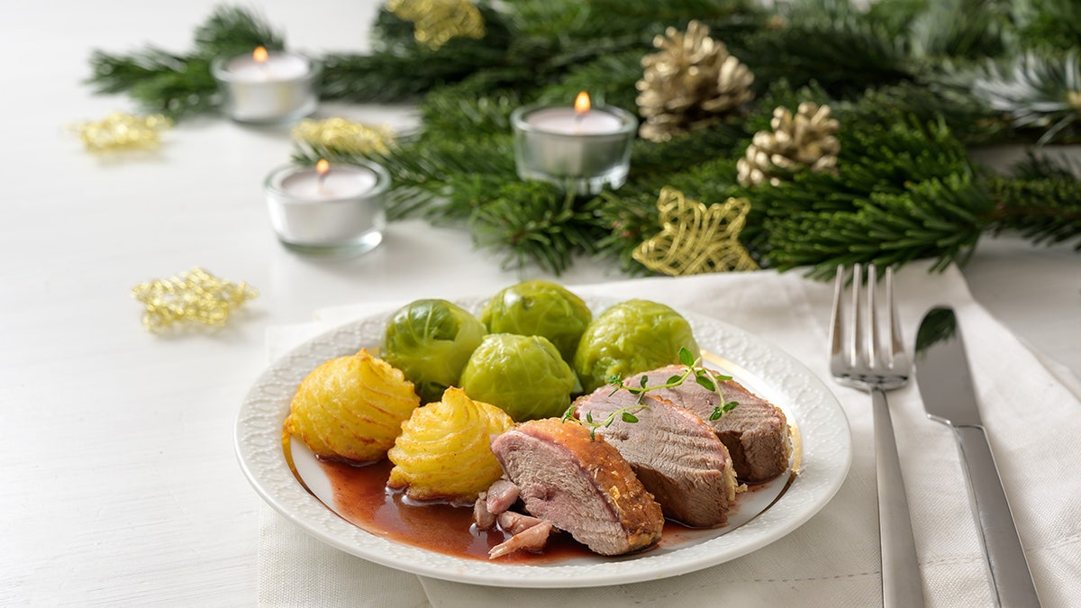 Holiday plate including duck, brussel sprouts, and duchess potatoes.