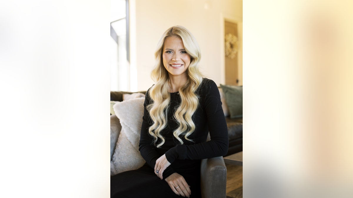 Elizabeth Smart in a black sweater smiling