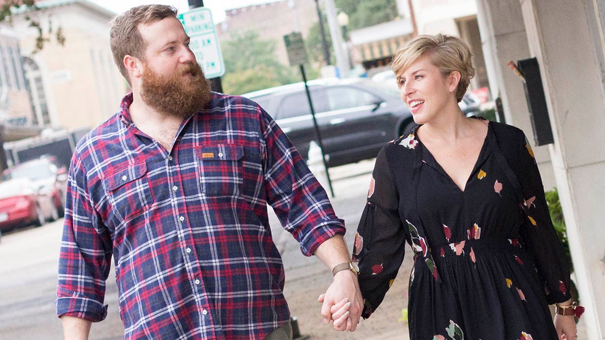 Ben and Erin Napier walking down the street holding hands